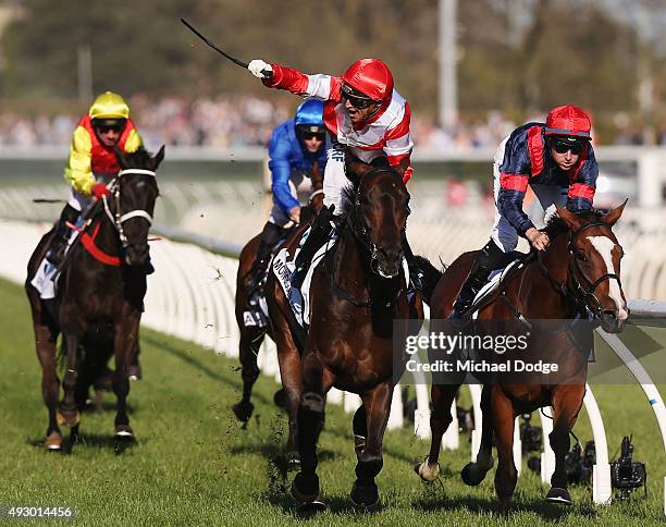 Jockey Opie Bosson riding Mongolian Khan wins ahead of Tommy Berry on Trip To Paris in race 9 the BMW the Caulfield Cup during Caulfield Cup Day at...