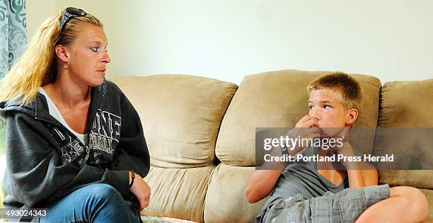 Sandra Watson, left listens as her son Dylan Young gestures about smoking during an interview about synthetic drugs that mimic marijuana on Tuesday...