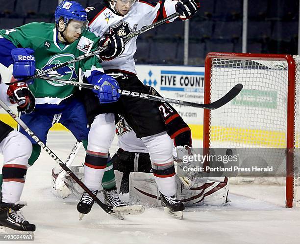 Russ Sinkewich of the Portland Pirates prevents Sean Collins of the Connecticut Whale from going after the puck as it sails just wide of the goal and...