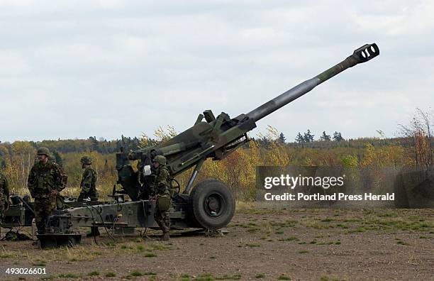 Saturday, October 20, 2001 -- Maine Army National Guardsmen load a round into a Howitzer gun on Saturday during training at the Canadian Forces Base...