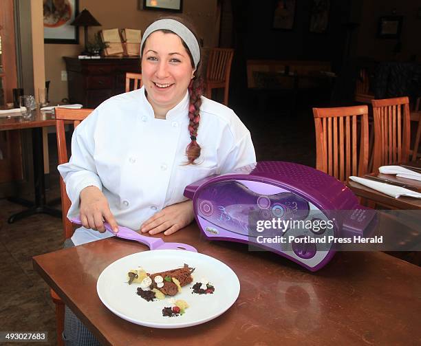 Addie Davis, executive pasty chef at 555 on Congress Street in Portland, poses with her gingerbread buche de Noel that she created with an Easy Bake...