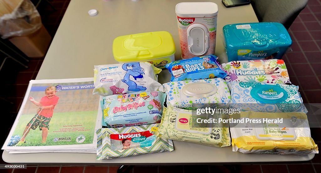 A table filled with a variety of "baby wipes" products are displayed at a press conference at the We