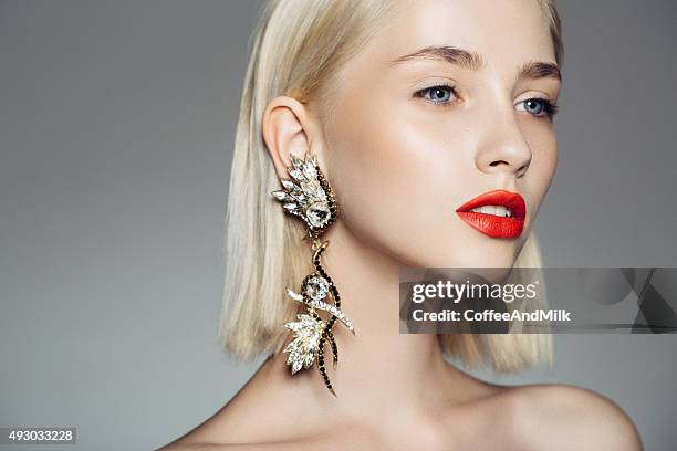 portrait of a nice looking woman with beautiful earings - red lips stock pictures, royalty-free photos & images