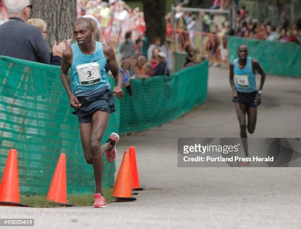 Micah Kogo of Kenya pulls away from Silas Kiproto on the hill at the entrance to Fort WIlliams Park during the TD Beach to Beacon in Cape Elizabeth...