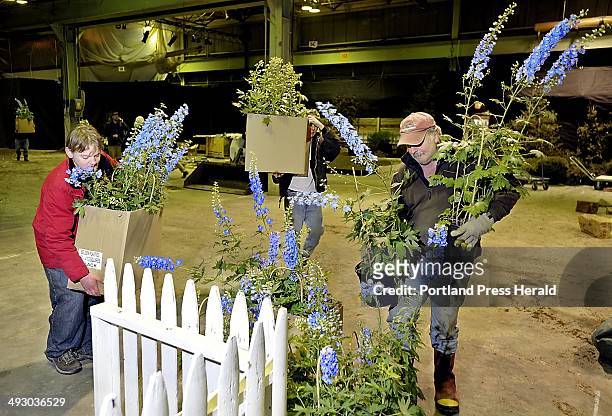 Monday, March 5, 2012. Irving Day, left, Michael Gelzinis, center, and Harvey Wilbur help carry flowers into the Flower Show at Portland Company on...