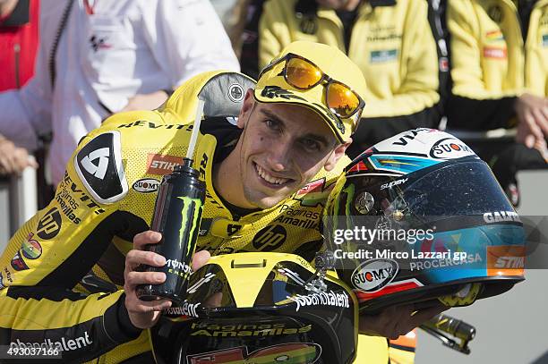 Alex Rins of Spain and Pagina Amarillas HP40 smiles and celebrates the pole position at the end of the qualifying practice during the MotoGP of...