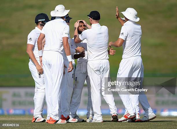 Adil Rashid of England celebrates with teammates after dismissing Younis Khan of Pakistan during day five of the 1st Test between Pakistan and...