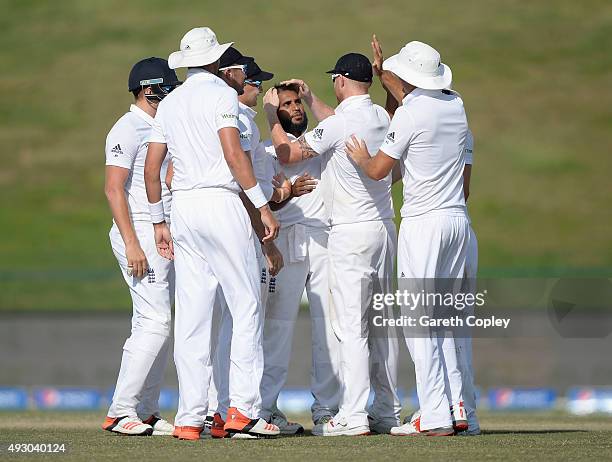 Adil Rashid of England celebrates with teammates after dismissing Younis Khan of Pakistan during day five of the 1st Test between Pakistan and...