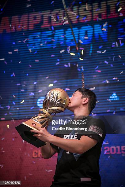 Yang Jin Hyeob, a professional video-game player, kisses the Adidas Championship Cup after winning the final round of the Electronic Arts Inc. Sports...
