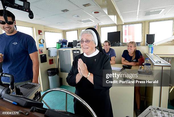 Sister Anne Marie Kiah of South Portland says a prayer before taking the helm of a Casco Bay Lines ferry while out on an outing with sisters...