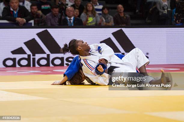 Priscilla Gneto of France holds Tsolmon Adiyasambuu of Mongolia during the -52kg preliminary round of the Paris Grand Slam 2015 at the Palais...