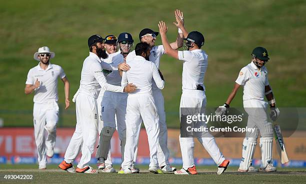 James Anderson of England celebrates with teammates after catching out Zulfiqar Babar of Pakistan from the bowling of Adil Rashid during day five of...