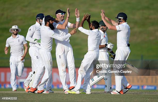 James Anderson of England celebrates with teammates after catching out Zulfiqar Babar of Pakistan from the bowling of Adil Rashid during day five of...