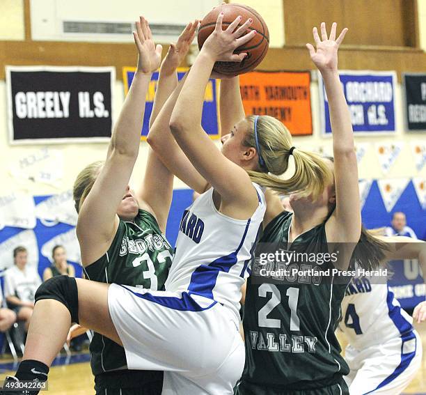 Tuesday., 2/14/11. OOB's Gillian Foss shoots the ball over Georges Valley Kennadi Grover, left, and Colleen Haskell as Old Orchard HS girls...