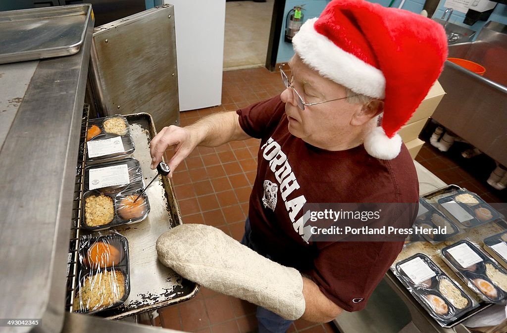 Tom O-Connor of Portland checks the temperature of the meals in the kitchen at the Westbrook Communi