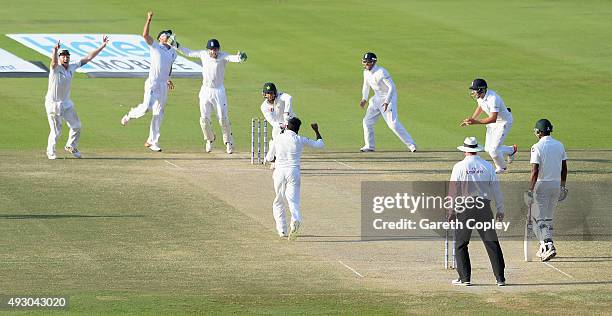 Adil Rashid of England celebrates dismissing Imran Khan of Pakistan during day five of the 1st Test between Pakistan and England at Zayed Cricket...