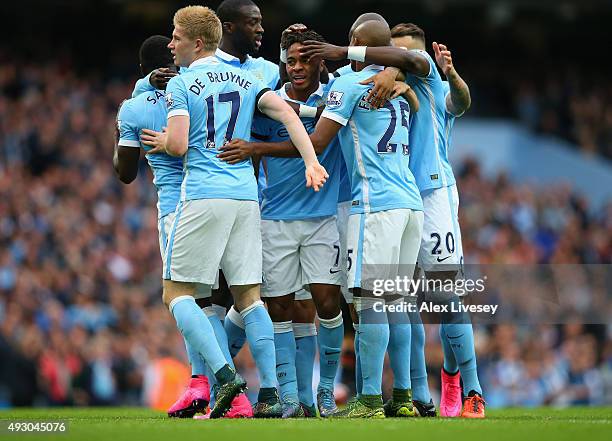 Raheem Sterling of Manchester City celebrates scoring his team's first goal with his team mates during the Barclays Premier League match between...