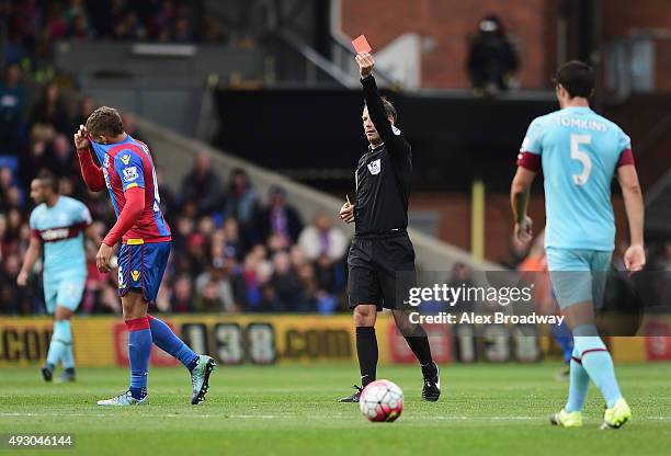 Dwight Gayle of Crystal Palace is shown a red card by referee Mark Clattenburg during the Barclays Premier League match between Crystal Palace and...