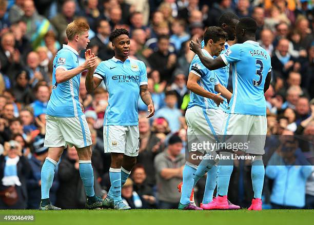 Raheem Sterling of Manchester City celebrates scoring his team's fourth and hat trick goal with his team mates during the Barclays Premier League...