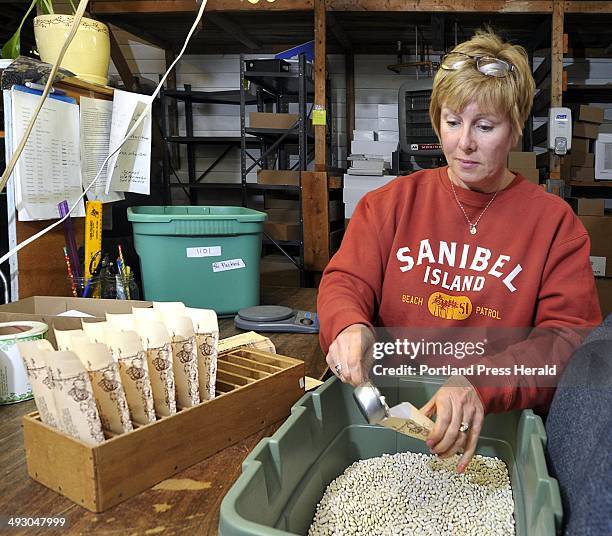 Thursday, April 19, 2012. Marybeth Dunham, an employee of Pinetree Garden Seeds, fills seed envelopes with "Slenderette Beans" for shipping to...