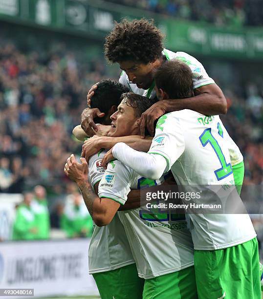 Max Kruse of Wolfsburg celebrates after scoring his teams third goal with Luiz Gustavo , Dante and Bas Dost of Wolfsburg during the Bundesliga match...