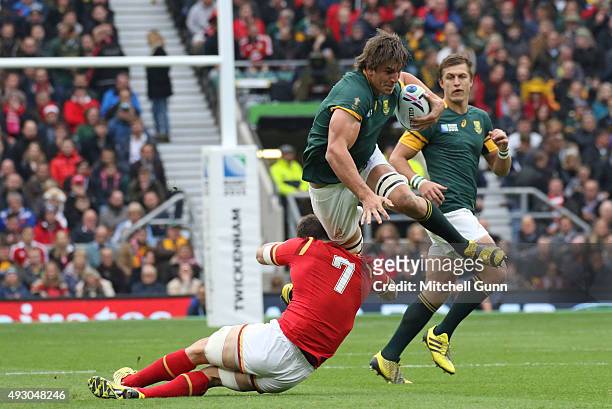 Eben Etzebeth of South Africa is tackled by Sam Warburton of Wales during the 2015 Rugby World Cup Quarter-Final match between South Africa and Wales...