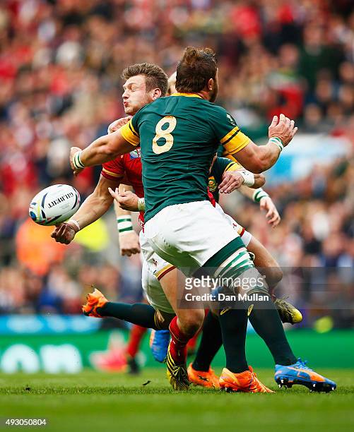 Dan Biggar of Wales off loads under presssure from Duane Vermeulen of South Africa during the build up the first Wales try during the 2015 Rugby...