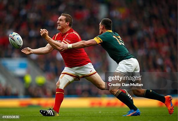 Gethin Jenkins of Wales passes under pressure from Jesse Kriel of South Africa during the 2015 Rugby World Cup Quarter Final match between South...