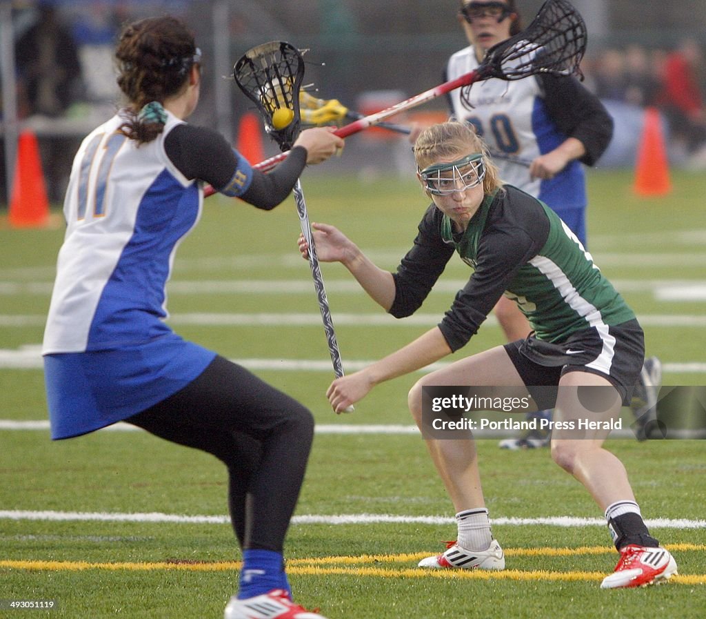 Martha Veroneau of Waynflete looks for an opening as Caroline McKeon of Falmouth moves in to defend