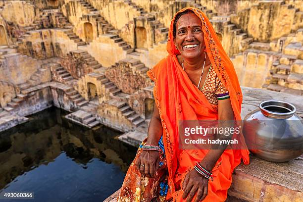 indian woman resting inside stepwell in village near jaipur, india - stepwell india 個照片及圖片檔