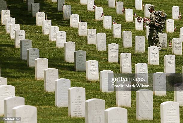 Member of the 3rd U.S. Infantry Regiment, 'The Old Guard,' participates in the 'Flags-In' ceremony May 24, 2014 at Arlington National Cemetery in...