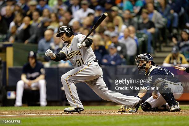 Jose Tabata of the Pittsburgh Pirates makes some contact at the plate during the game against the Milwaukee Brewers during the game at Miller Park on...