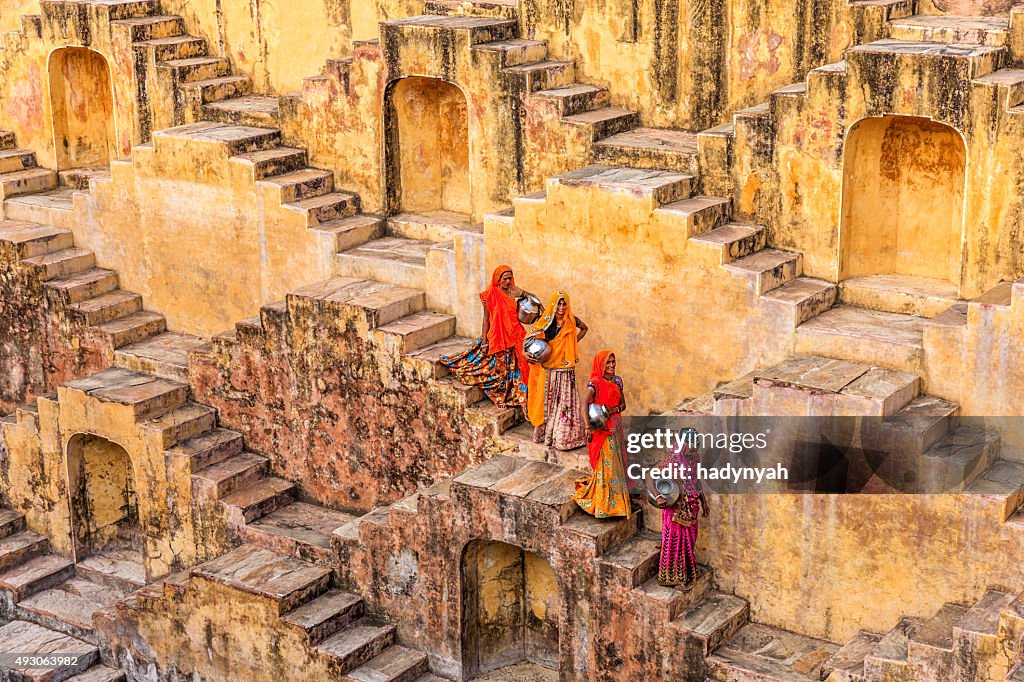 Indian women carrying water from stepwell near Jaipur