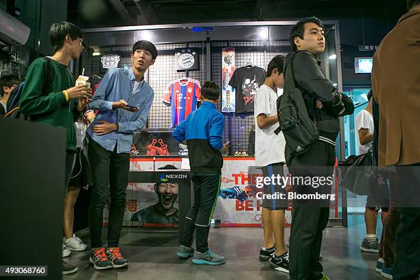 Fans stand in line to enter the Nexon Co. E-Sports Stadium prior to the final round of the Electronic Arts Inc. Sports FIFA Online Championship in...