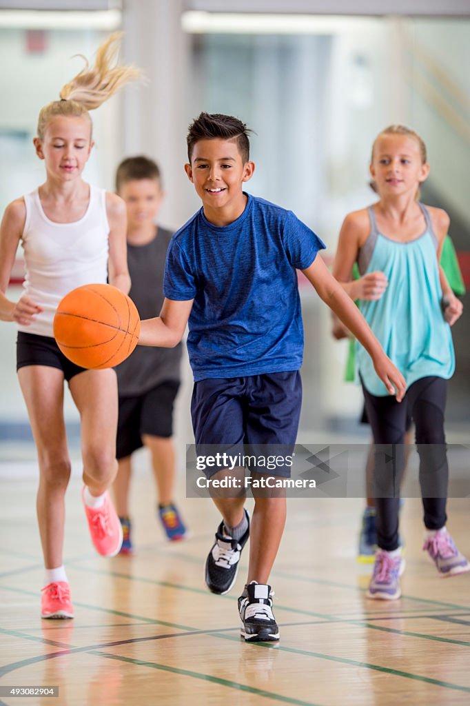 Children Playing Basketball at the Gym