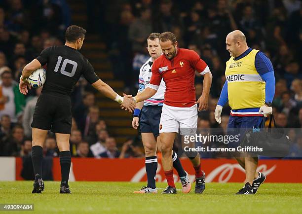 Dan Carter of the New Zealand All Blacks consoles Frederic Michalak of France as he leaves the field injured during the 2015 Rugby World Cup Quarter...