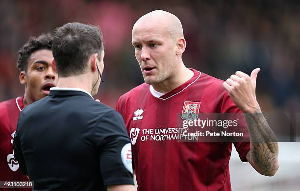 Ryan Cresswell of Northampton Town makes a point to referee Darren England during the Sky Bet League Two match between Cambridge United and...