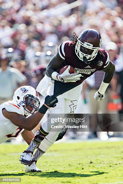 De'Runnya Wilson of the Mississippi State Bulldogs runs the ball and is hit by Lyn Clark of the Northwestern State Demons at Davis Wade Stadium on...