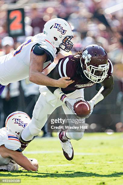 De'Runnya Wilson of the Mississippi State Bulldogs is tackled by Peyton Guidry of the Northwestern State Demons at Davis Wade Stadium on September...