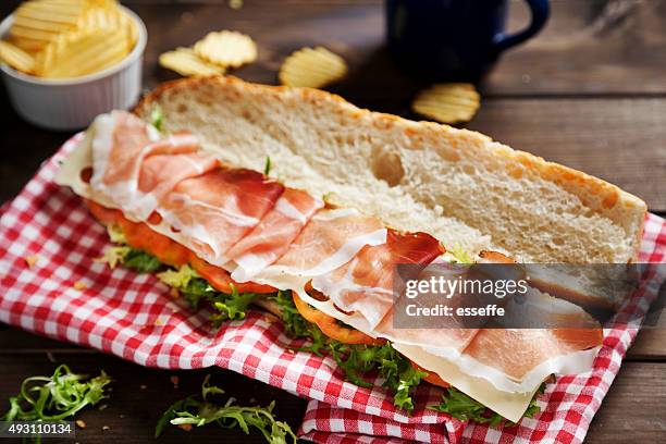 baguette with prosciutto salad cheese ant tomato - prosciutto stock pictures, royalty-free photos & images