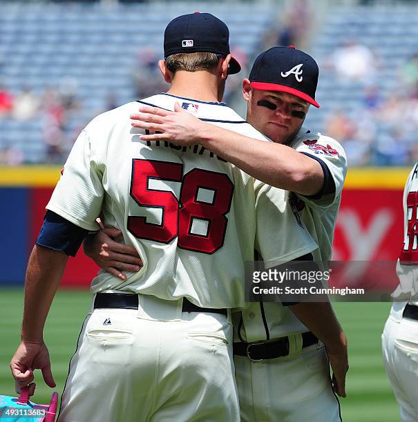 Ian Thomas of the Atlanta Braves is greeted by Tyler Pastornicky before the game against the Chicago Cubs at Turner Field on May 11, 2014 in Atlanta,...