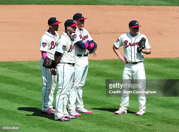 Atlanta Braves Infielders Andrelton Simmons, Chris Johnson, Freddie Freeman, and Tyler Pastornicky wait during a pitching change against the Chicago...