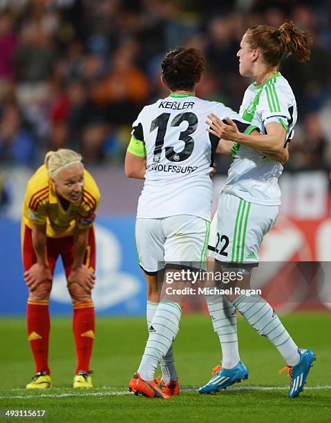 Caroline Seger of Tyreso FF looks on as Verena Faisst of VfL Wolfsburg celebrates with team mate Nadine Kessler as she scores their third goal during...