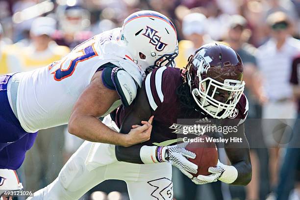 De'Runnya Wilson of the Mississippi State Bulldogs is tackled by Peyton Guidry of the Northwestern State Demons at Davis Wade Stadium on September...