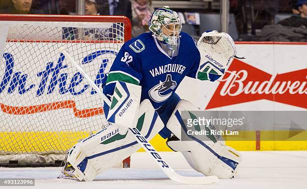 Goalie Richard Bachman of the Vancouver Canucks makes a save during the pre-game warm up prior to the start of NHL action against the Calgary Flames...