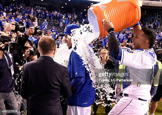 Salvador Perez dumps the Gatorade water cooler on Edinson Volquez of the Kansas City Royals after defeating the Toronto Blue Jays in Game 1 of the...