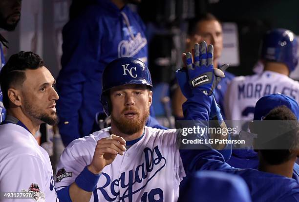 Ben Zobrist of the Kansas City Royals is congratulated by teammates in the dugout after scoring in the bottom of the eighth inning of Game 1 of the...