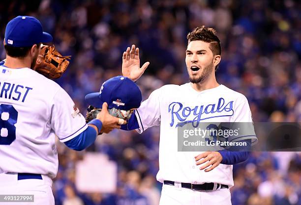 Eric Hosmer of the Kansas City Royals celebrates with teammates Ben Zobrist after scoring in the bottom of the eighth inning of Game 1 of the ALCS...