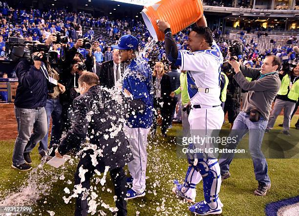 Salvador Perez dumps the Gatorade water cooler on Edinson Volquez of the Kansas City Royals after defeating the Toronto Blue Jays in Game 1 of the...