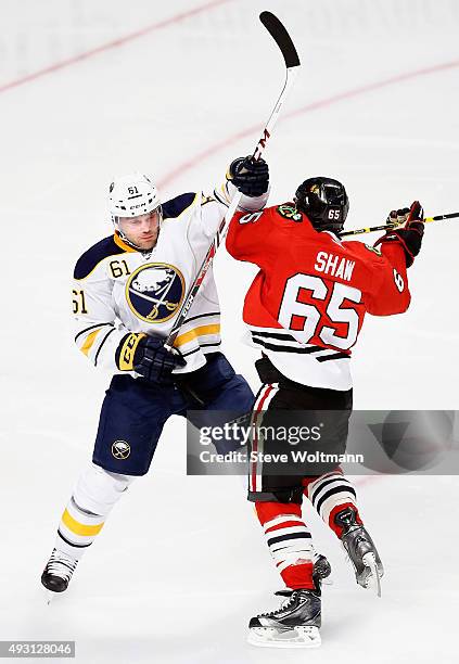 Andrew Shaw of the Chicago Blackhawks plays against Andre Benoit of the Buffalo Sabres during the game at the United Center on October 11, 2014 in...